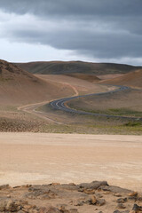 A mountain road leads to mountains in the volcanic zone in northern Iceland. Road to the Krafla geothermal area