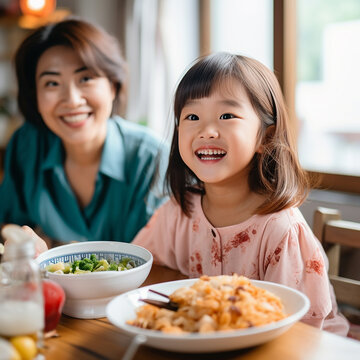 Food, home and Japanese parents and child at table for lunch, breakfast and eating meal together. Happy family, culture and mother, father and young girl in house for bonding, relationship and love