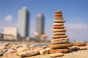 Fototapeta na wymiar Stack of balancing stones on beach in barcelona