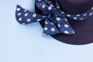 Blue hat with ribbon on blue background. Summer concept. Top view with copy space