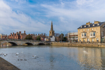 A view from the southern shore across the River Great Ouse towards the centre of Bedford, UK on a bright sunny day