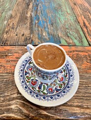 Cup of Turkish coffee on colorful wooden table, Istanbul, Turkey 