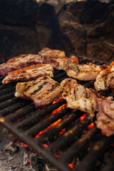 Grilling meat on a flaming barbecue
