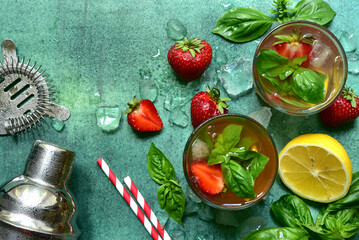 Fresh ingredients and props for making summer cold cocktail strawberry mojito. Top view with copy space.