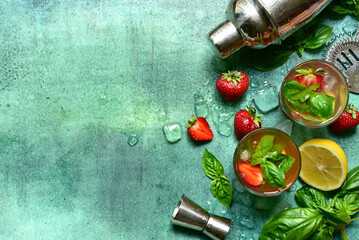 Fresh ingredients and props for making summer cold cocktail strawberry mojito. Top view with copy...