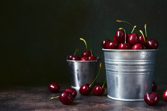 Fresh ripe organic cherry in a metal bucket.