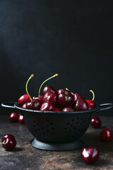 Fresh ripe organic cherry in a metal bucket.