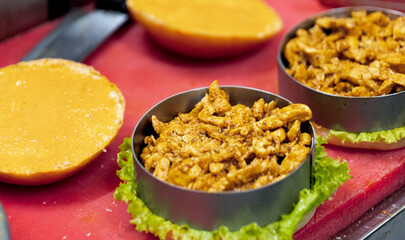 Tasty appetizer with meat and cheese burger on a red background