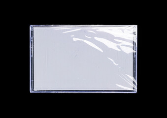 Old cassette tape case on black background. Isolated music transparent mockup. Clean cover box...