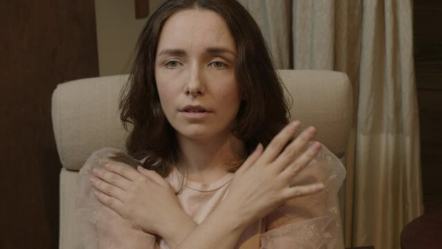 Female touching and tapping her shoulders, crossing hands. Butterfly hug. Psychology and self-care concept. Focus changing.