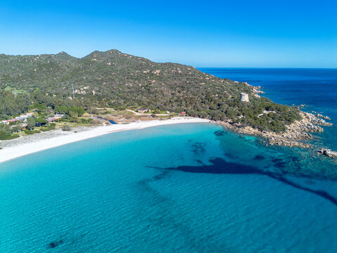 Cala Pira beach and tower, with white sand and crystal clear water seen from above with drone. Castiadas, Sardinia, Italy