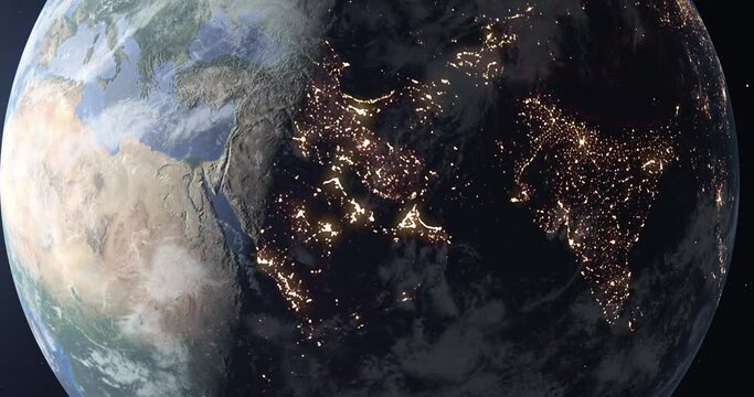 Fly over planet Earth during the transition from day to night, view from space. City lights in the Middle East, India and Central Asia glow at night. 3D animation 4K. Contains NASA images.