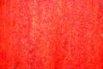 Red metal and paint creating textured wall background