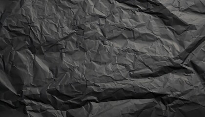 Heavy crumpled black paper texture in low light background