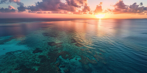 Obraz premium Great Barrier Reef on the coast of Queensland, Australia seascape. Coral sea marine ecosystem wallpaper background at sunset, with an orange purple sky in the evening golden hour