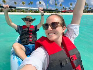 Photo selfie of a smiling young couple in a kayak on their luxury honeymoon vacation in a resort hotel in a Maldives island
