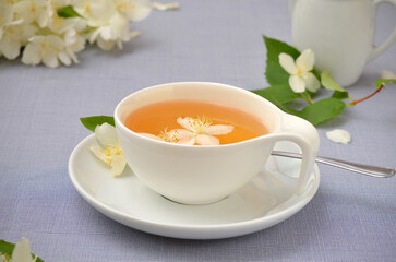 still life in light colors green tea and garden jasmine flowers
