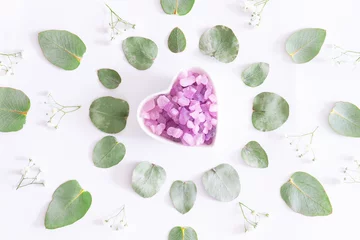 Cercles muraux Salon de beauté Spa and wellness concept. Aromatic Himalaya salt and essential massage oil on white background with flowers and eucalyptus leaves top view.