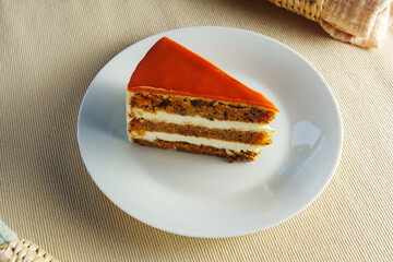 Featuring a slice of moist and flavorful carrot cake beautifully presented on a pristine white plate.