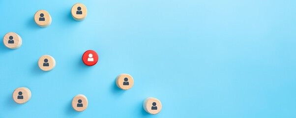 Wooden cubes with person icon on blue background. Copy space