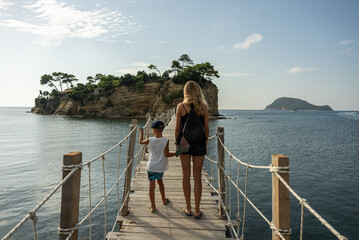 Family stands on a wooden bridge on vacation in Greece. Cameo island in Greece..Cameo Wedding...