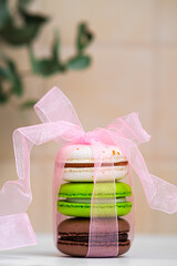 Sweet and cute colorful pasta dessert wrapped in ribbon. Cozy bakery photo for cafe decoration, greeting card, print