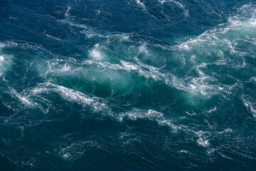 The Saltstraumen current carves intricate patterns in the sea, ideal for a background with its...
