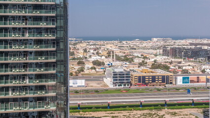 Aerial panoranic view to Dubai City Walk district behind skyscraper timelapse from above