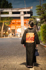 Japanese Female Kimono Portrait back view photography. Kyoto, Japan. Japanese traditional Shrine Torii.