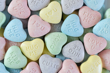 Pastel candy conversation hearts background for Valentine's Day - love u, kiss, hug, XOXO, cutie