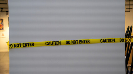 Yellow caution tape with 'DO NOT ENTER' text against a white background.