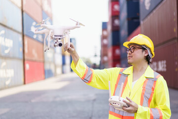 Container yard staff prepares a drone or UAV flying to survey - inspect around the container site.