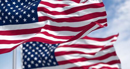 Flags of the United States of America waving on a sunny day