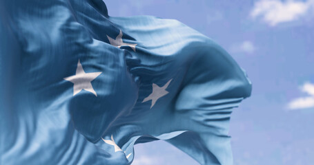 National flag of Federated states of Micronesia waving on a clear day - obrazy, fototapety, plakaty