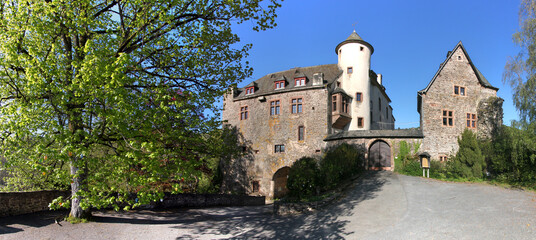 Panoramic view of Neuerburg castle with medieval tower and Renaissance oriel window, Eifel region...