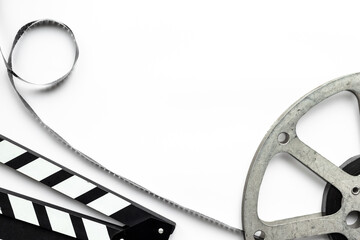 Cinema and filmmaker concept with film reels and clapperboard - obrazy, fototapety, plakaty