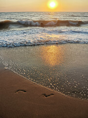 Tranquil Evening Seascape, Summer Sunset Casting Warm Glow Over Calm Waters with Clouds, Serene Beauty of Dusk