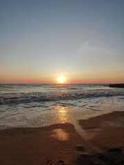 Tranquil Evening Seascape, Summer Sunset Casting Warm Glow Over Calm Waters with Clouds, Serene Beauty of Dusk
