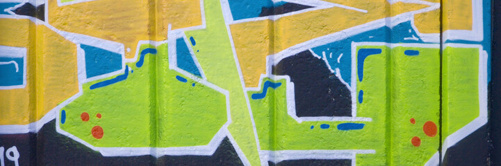 Colorful background of graffiti painting artwork with bright aerosol outlines on wall. Old school...