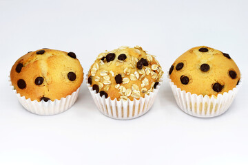 Delicious homemade muffins - with chocolate chips or with chocolate chips and oat flakes, white background