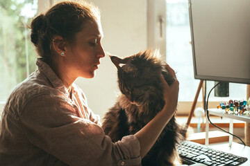 Woman and Maine Coon at Home Office