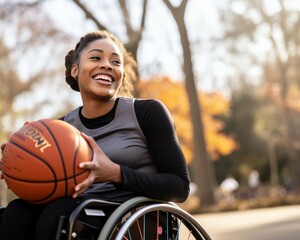 Smiling young African American woman in a wheelchair holding a basketball outdoor