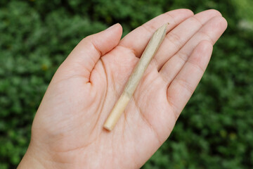 Woman holding a marijuana cannabis joint