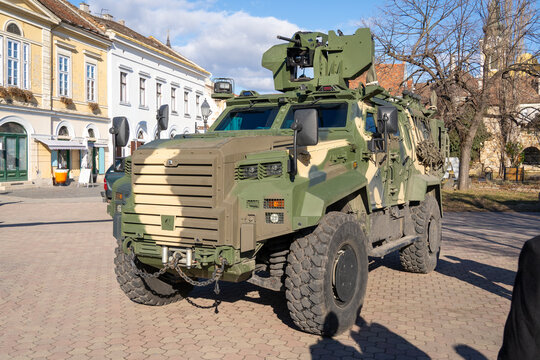 A camouflaged modern 4x4 MRAP armored fighting vehicle on the street of a Hungarian city