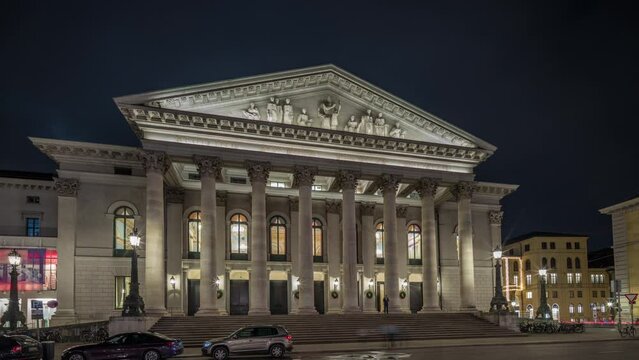 Munich National Theatre or Nationaltheater on the Max Joseph square night timelapse hyperlapse. Illuminated historic opera house front view, home of the Bavarian State Opera. Germany
