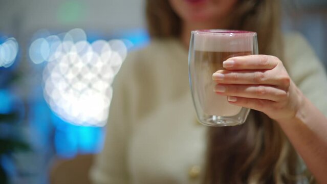 Woman drinking lavender raf coffee at a restaurant