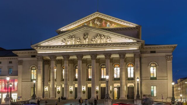 Munich National Theatre or Nationaltheater on Max Joseph square day to night transition timelapse. Historic opera house, home of the Bavarian State Opera. Evening illumination after sunset. Germany