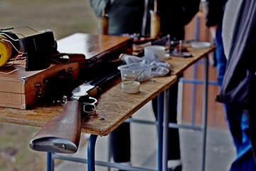 Fototapeta na wymiar Rifle and accessories on the shooting range table 01