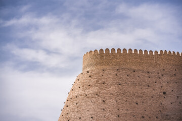 Ark Citadel with brick fortress walls in the ancient city of Bukhara in Uzbekistan on a warm summer sunny day, a stone fort
