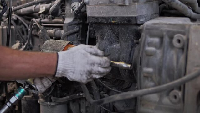 Disassembly of a truck engine using an air wrench